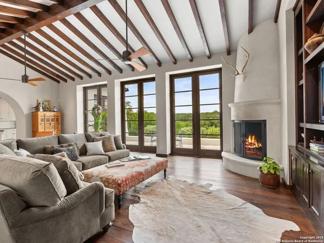 a kitchen with white cabinets and window