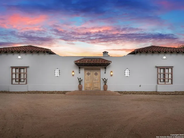 an aerial view of residential houses with outdoor space and trees