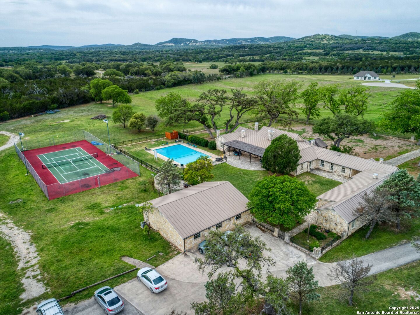 2835 Palomino Springs Bandera, TX 78003 - Photo 74 of 77 an aerial view of residential house with outdoor space and lake view