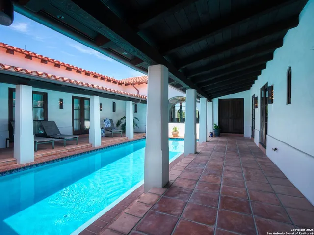 a living room with a couch a fireplace and a flat screen tv
