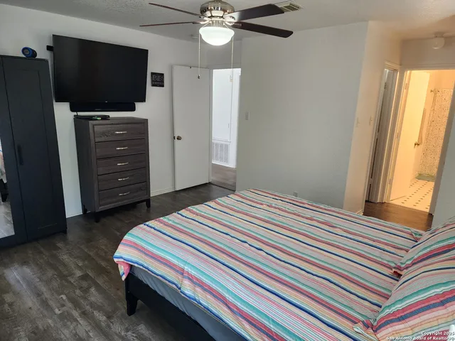 a bedroom with a bed and a flat screen tv