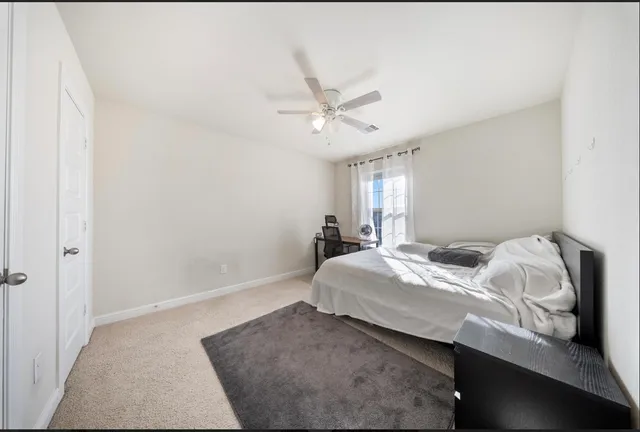 a bedroom with bed and a window