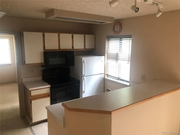a kitchen with a refrigerator and a window