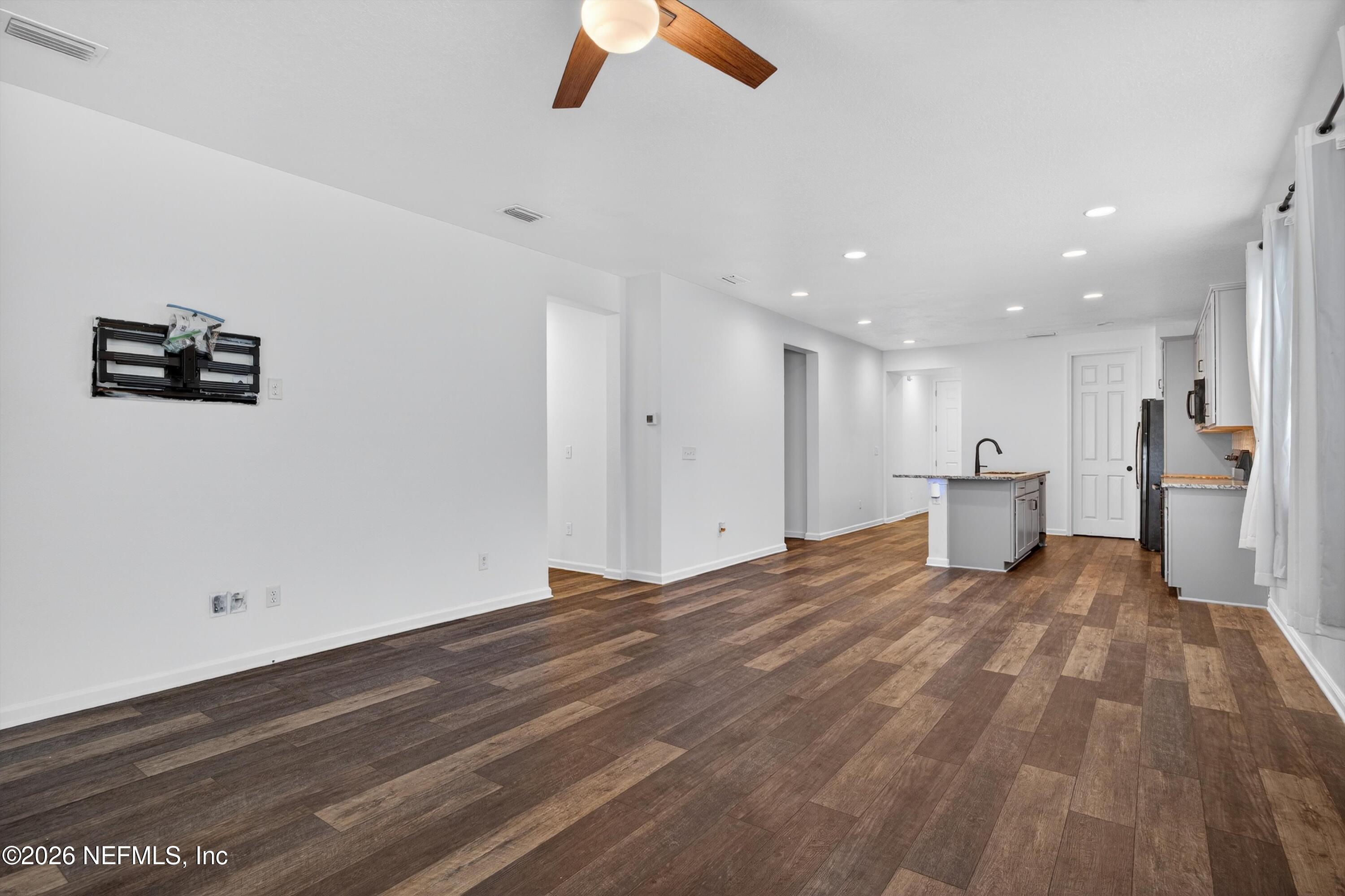 1062 Persimmon Drive Middleburg, FL 32068 - Photo 16 of 45 a view of a livingroom with a workspace hardwood floor and a ceiling fan