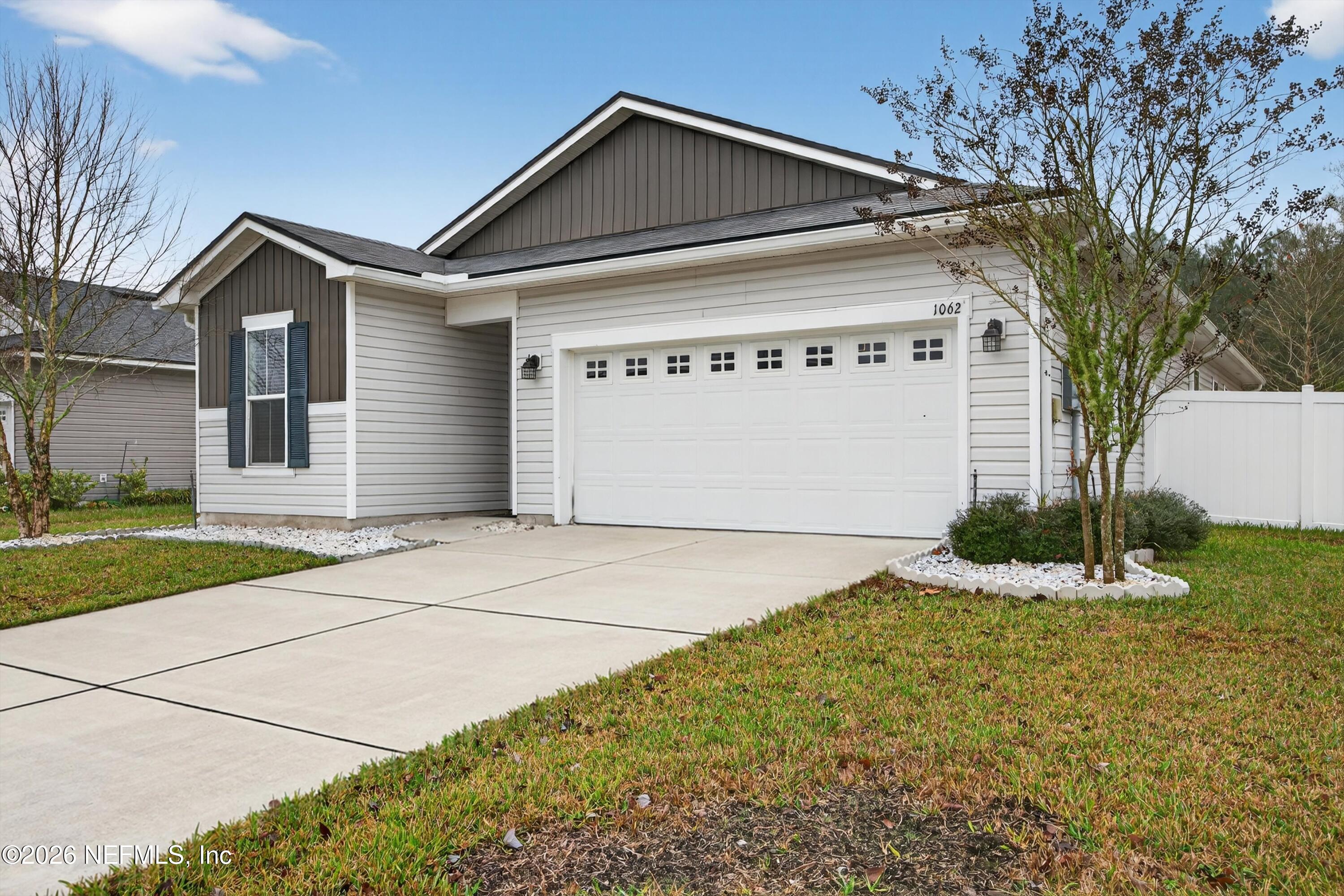 1062 Persimmon Drive Middleburg, FL 32068 - Photo 3 of 45 a front view of a house with garden