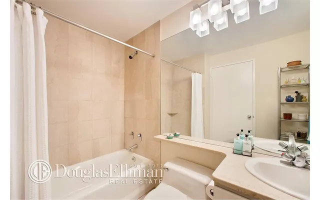 a bathroom with a sink a bathtub and a mirror