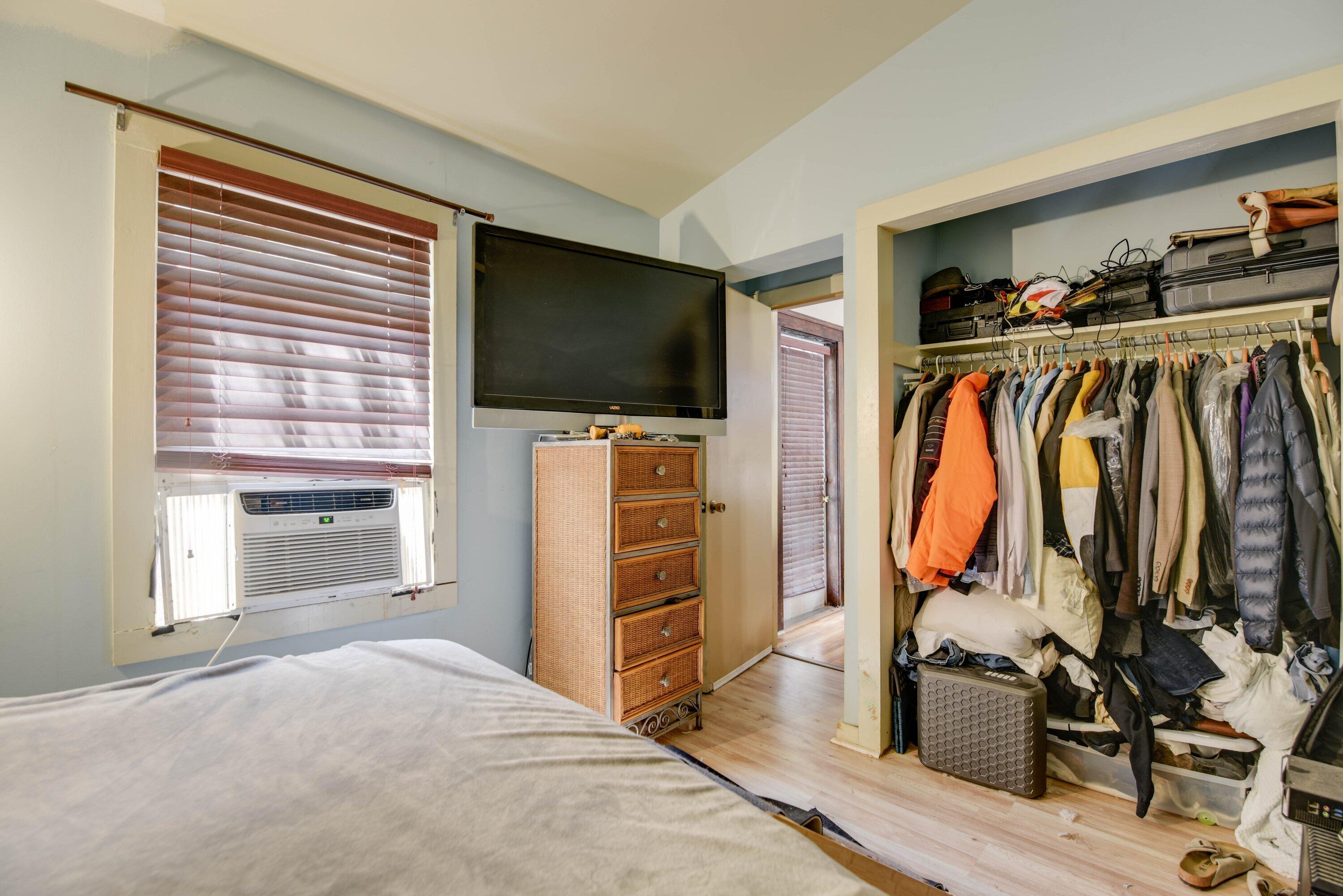 1306 Virginia Street Key West, FL 33040 - Photo 22 of 30 a view of walk in closet with clothes and shoes