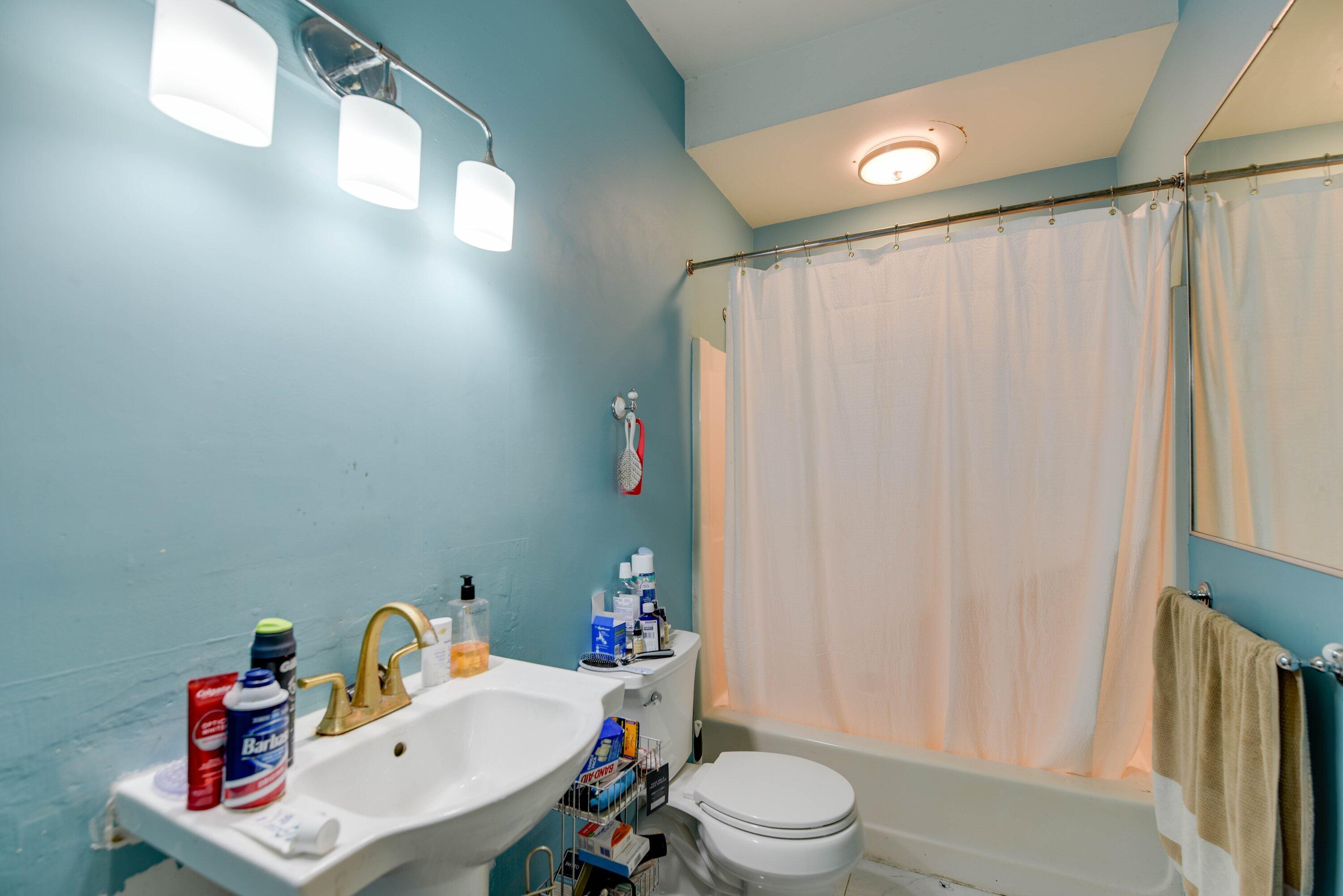 1306 Virginia Street Key West, FL 33040 - Photo 23 of 30 a bathroom with a sink vanity mirror and toilet