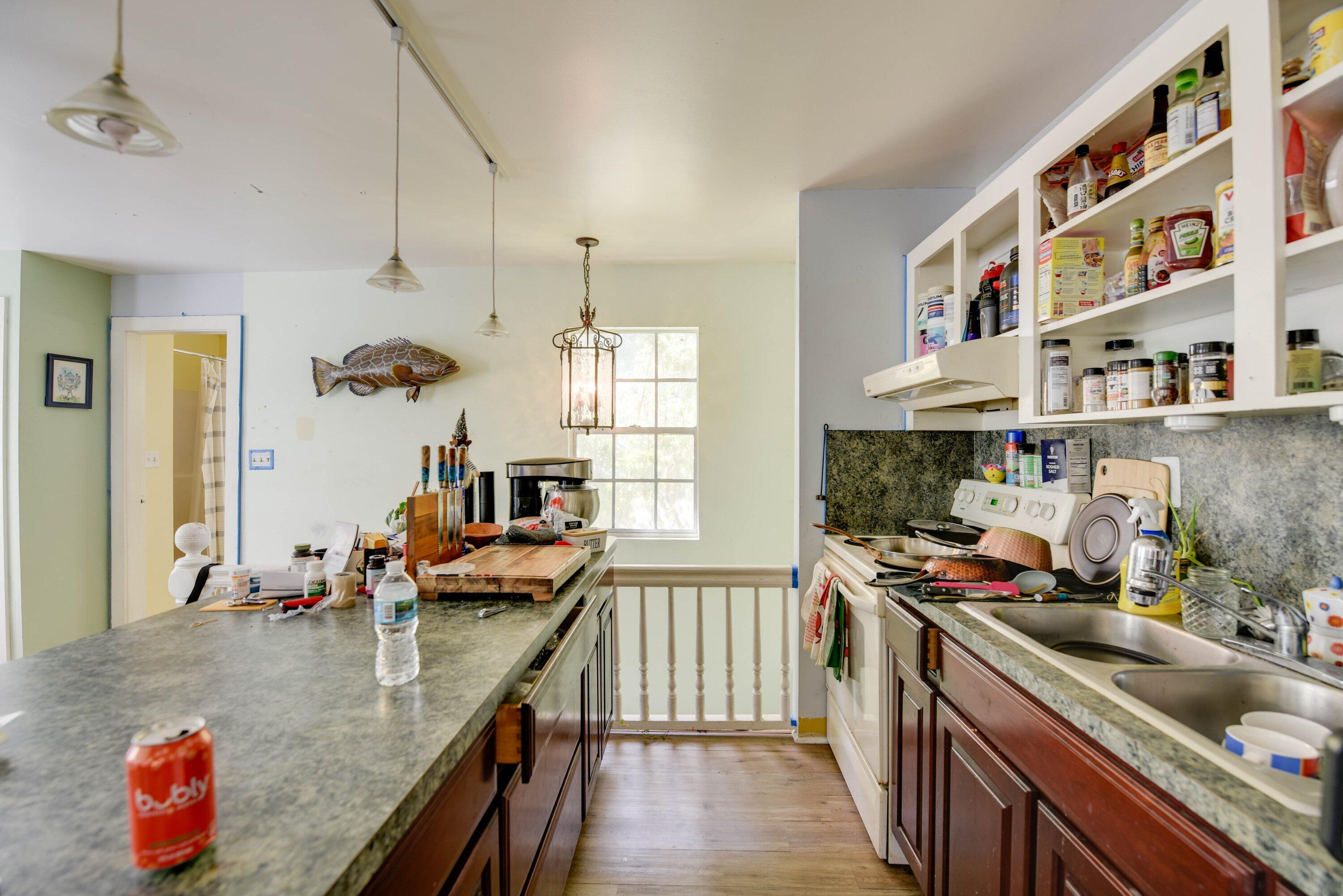 1306 Virginia Street Key West, FL 33040 - Photo 26 of 30 a kitchen with stainless steel appliances granite countertop a sink a stove and a wooden floors