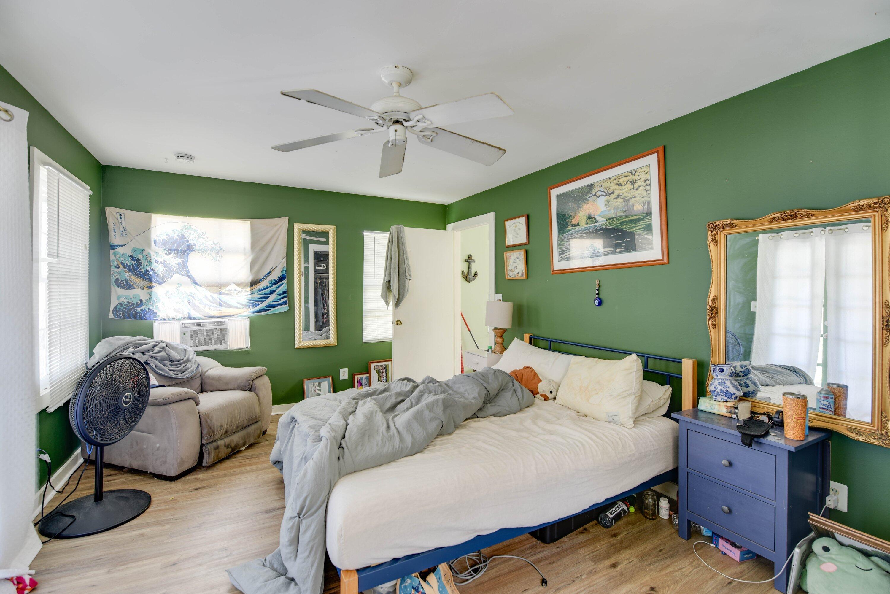 1306 Virginia Street Key West, FL 33040 - Photo 27 of 30 a bedroom with a bed and large windows