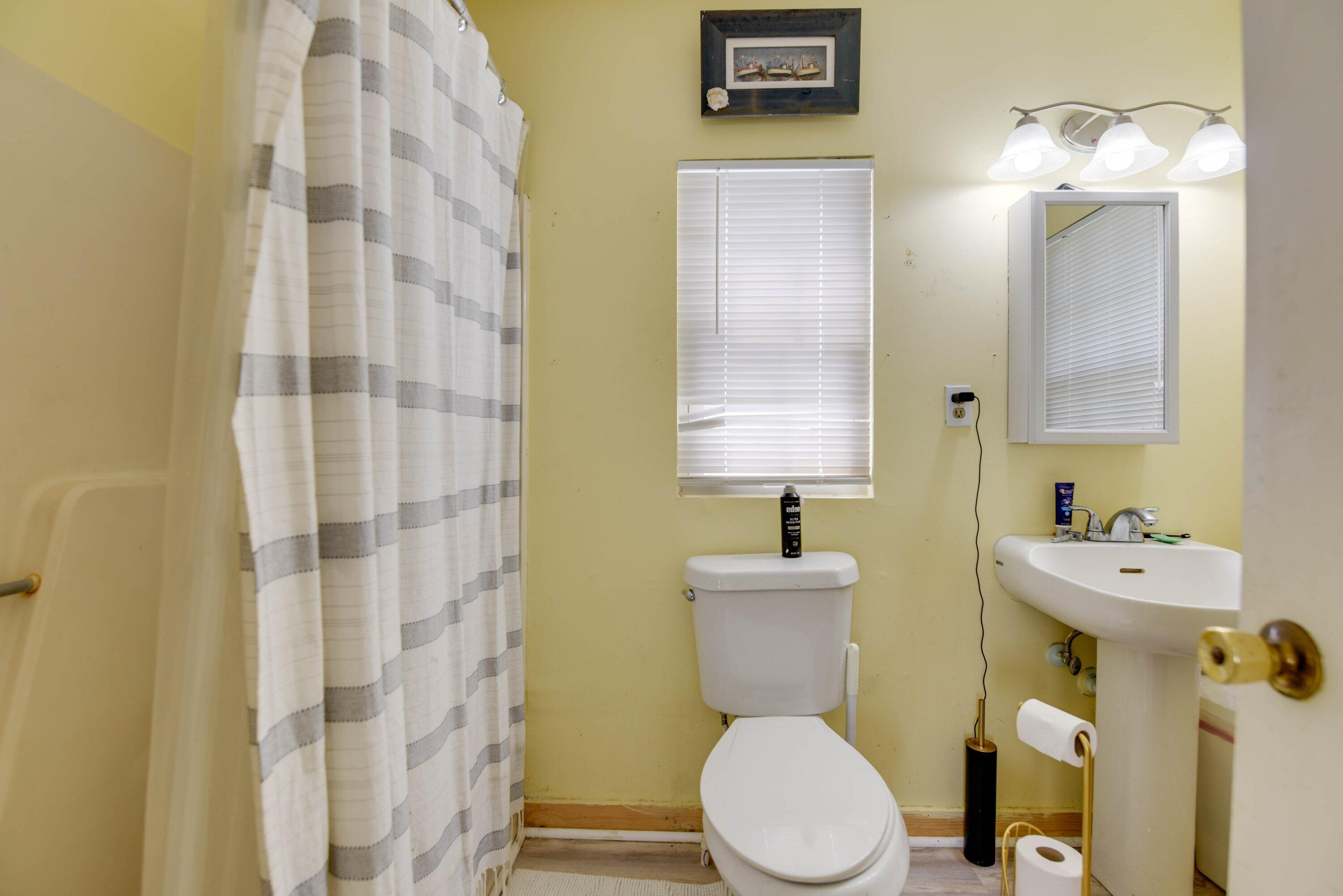 1306 Virginia Street Key West, FL 33040 - Photo 28 of 30 a white toilet sitting next to a bathroom sink