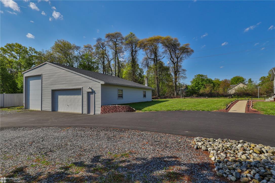 205 West Moorestown Road Wind Gap, PA 18091 - Photo 14 of 20 A spacious garage and asphalt driveway enhance this property's practicality and curb appeal.