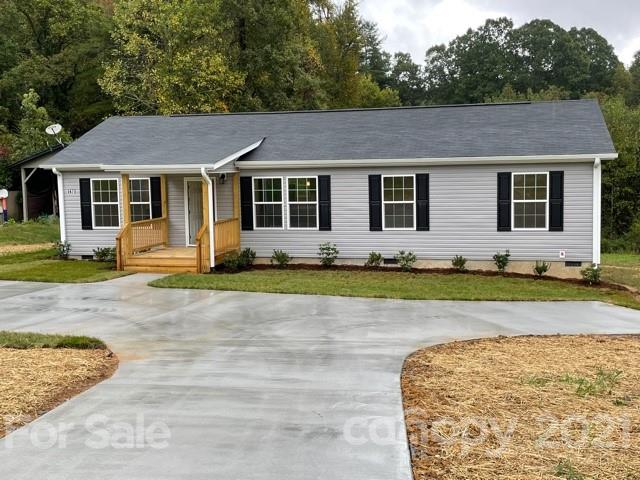 1471 Howard Gap Loop Road Flat Rock, NC 28731 - Photo 1 of 24 a front view of a house with yard