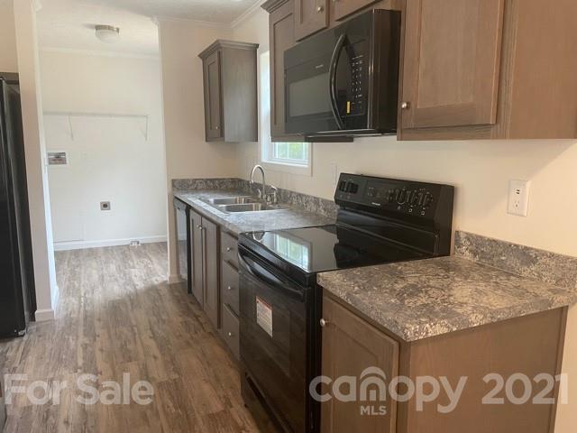 1471 Howard Gap Loop Road Flat Rock, NC 28731 - Photo 12 of 24 a kitchen with a stove and a sink