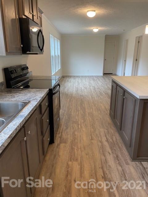 1471 Howard Gap Loop Road Flat Rock, NC 28731 - Photo 13 of 24 a kitchen with a wooden floor and a sink