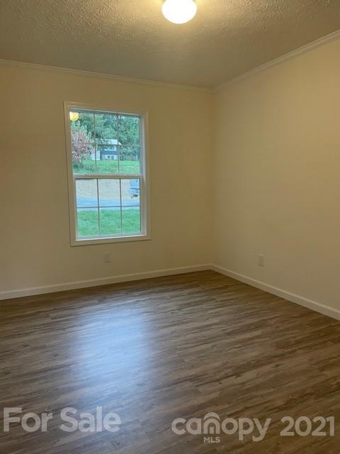 1471 Howard Gap Loop Road Flat Rock, NC 28731 - Photo 20 of 24 an empty room with wooden floor and windows