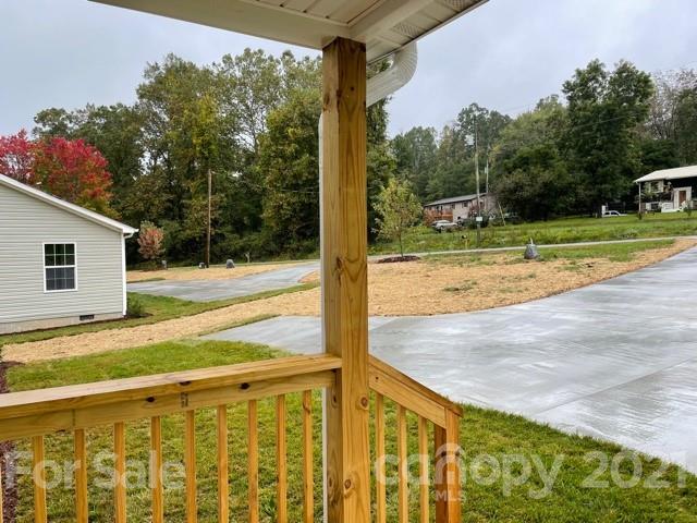 1471 Howard Gap Loop Road Flat Rock, NC 28731 - Photo 4 of 24 a view of a porch with yard