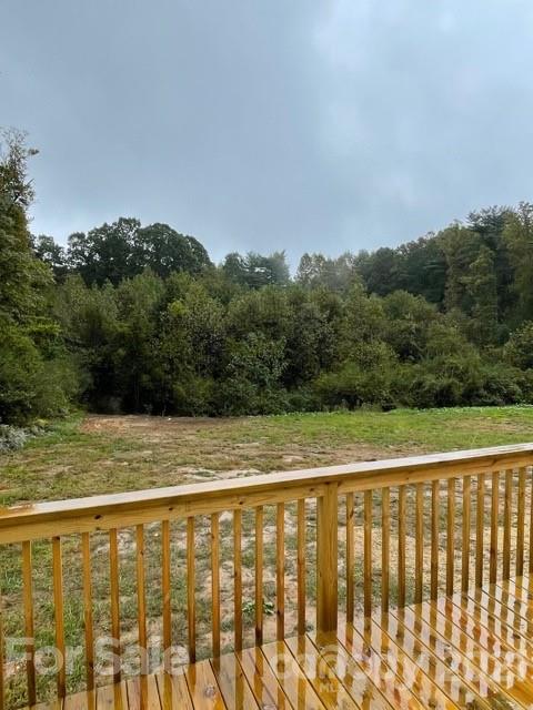 1471 Howard Gap Loop Road Flat Rock, NC 28731 - Photo 5 of 24 a view of a balcony with an outdoor space and seating area