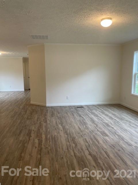 1471 Howard Gap Loop Road Flat Rock, NC 28731 - Photo 8 of 24 an empty room with wooden floor and windows