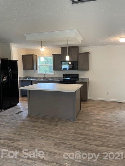 1471 Howard Gap Loop Road Flat Rock, NC 28731 - Photo 9 of 24 a large kitchen with stainless steel appliances a large counter top a stove and a refrigerator