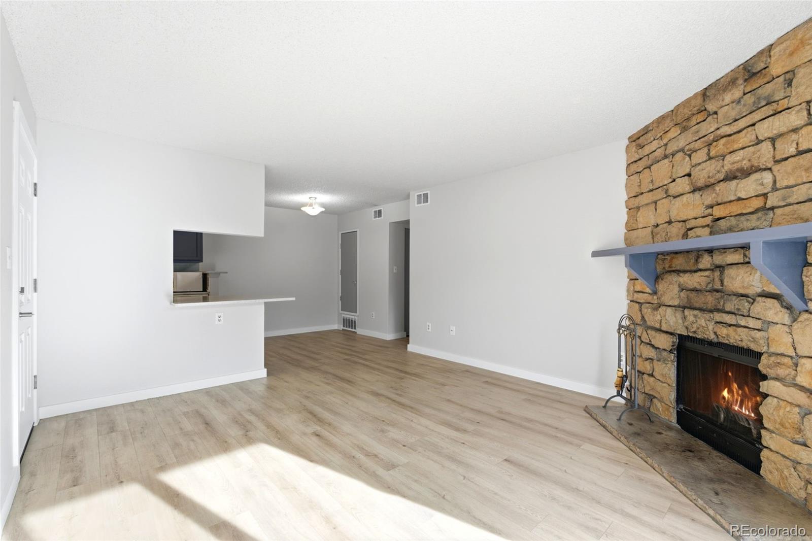 4400 South Quebec Street, Unit 108M Denver, CO 80237 - Photo 6 of 28 a view of a livingroom with a fireplace