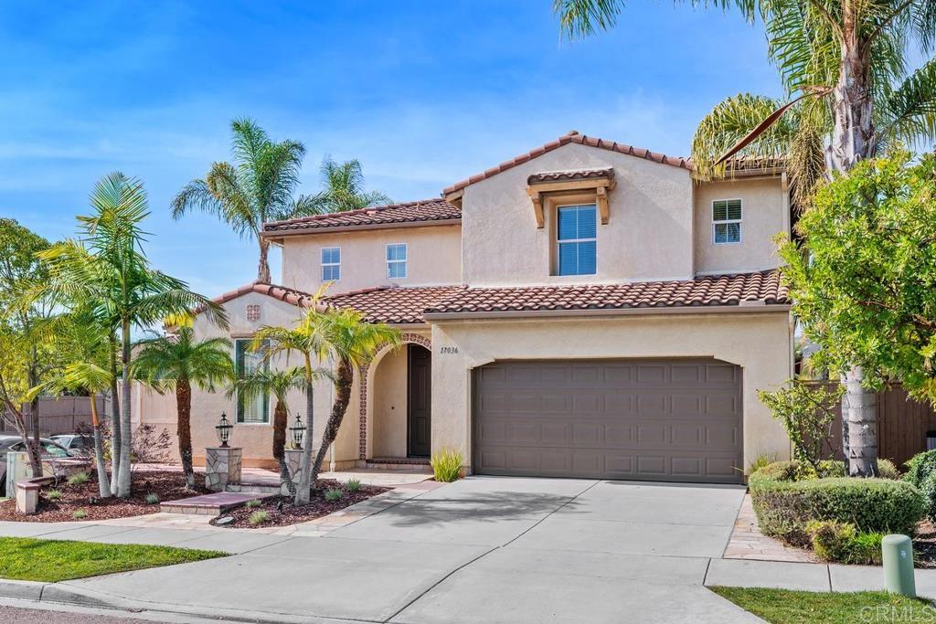 a front view of a house with garage