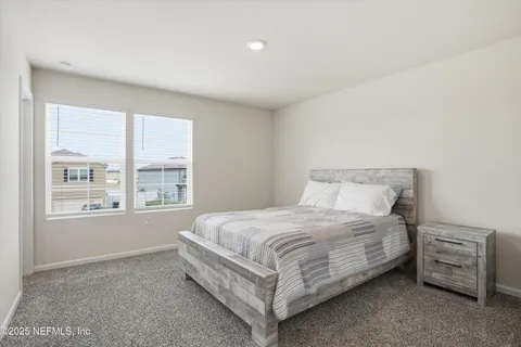 a bedroom with furniture and a window