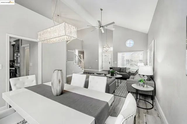 a view of a dining room with furniture and a chandelier