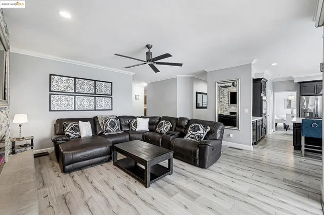 a view of a dining room with furniture large windows and wooden floor