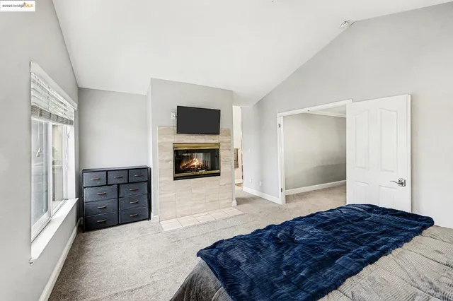 a bedroom with a large bed and a large window