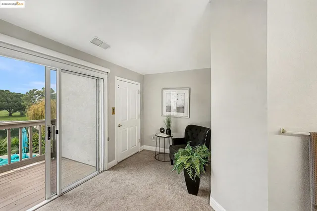 a living room with a fireplace and a potted plant