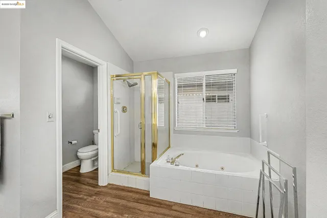 a spacious bathroom with a shower a sink and a mirror