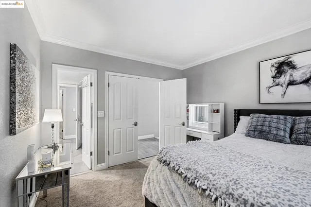 a bedroom with a large bed and a chandelier