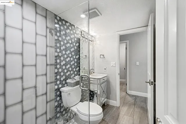 a bathroom with a toilet and a shower