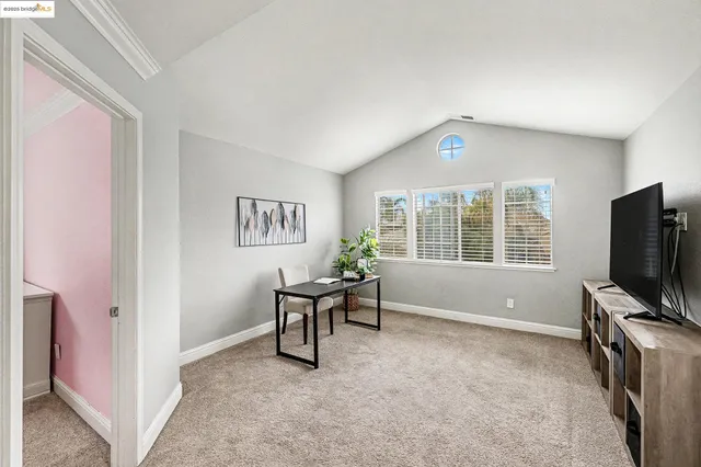a view of a livingroom with furniture and a window