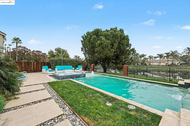 a view of a park with of a house in the background
