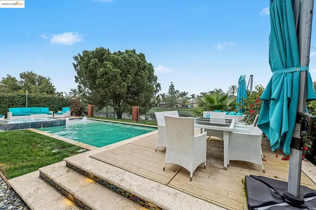 a view of a backyard with sitting area