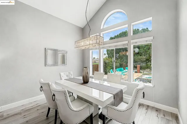 a view of a dining room with furniture wooden floor and a chandelier