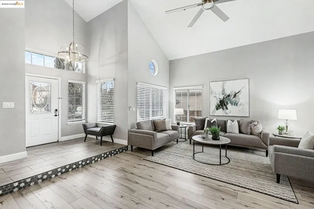 a living room with furniture and a chandelier