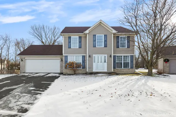 a front view of a house with a dirt yard