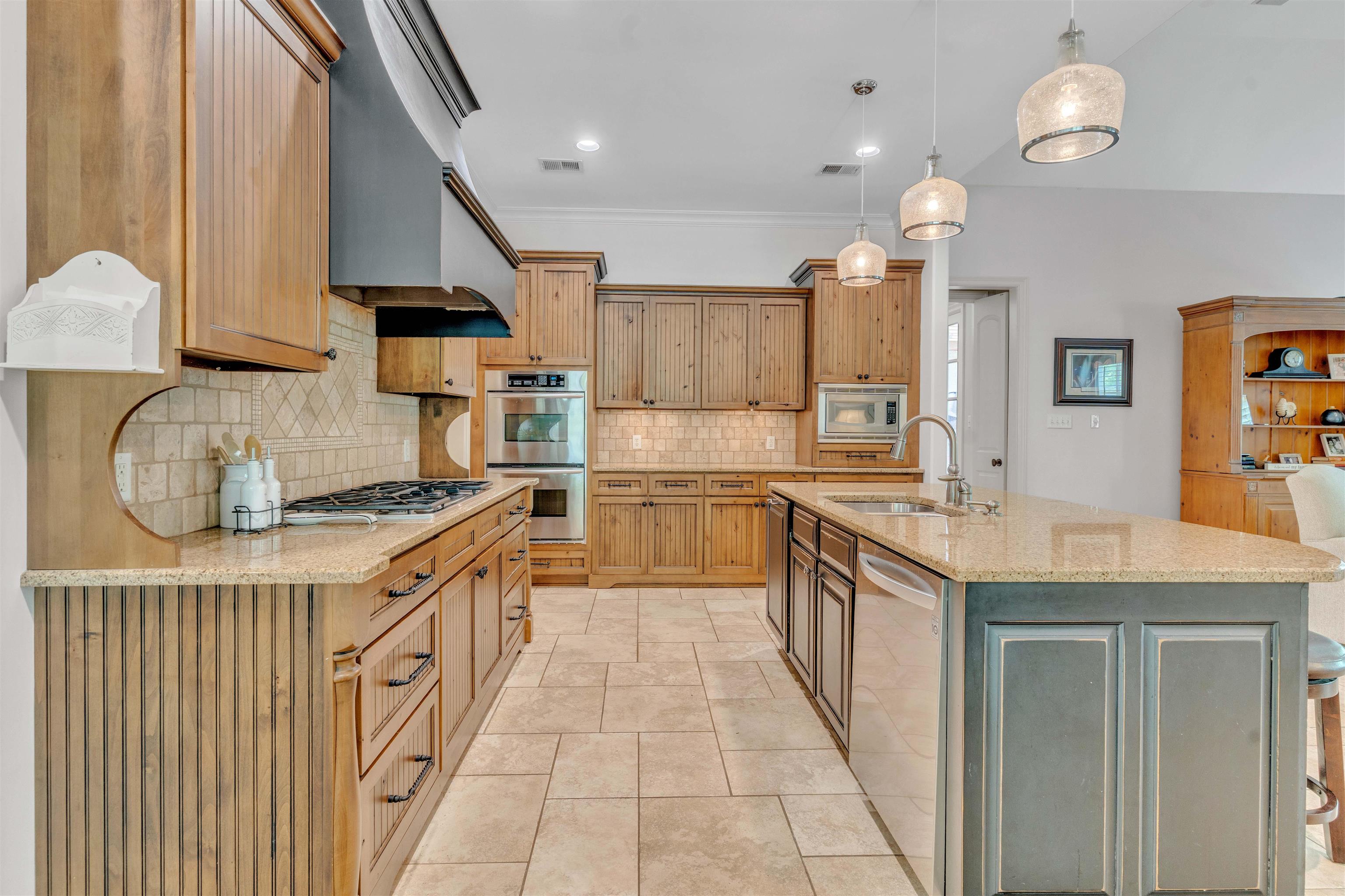 1218 Braystone Trail Collierville, TN 38017 - Photo 15 of 40 a kitchen with stainless steel appliances granite countertop a sink and a stove