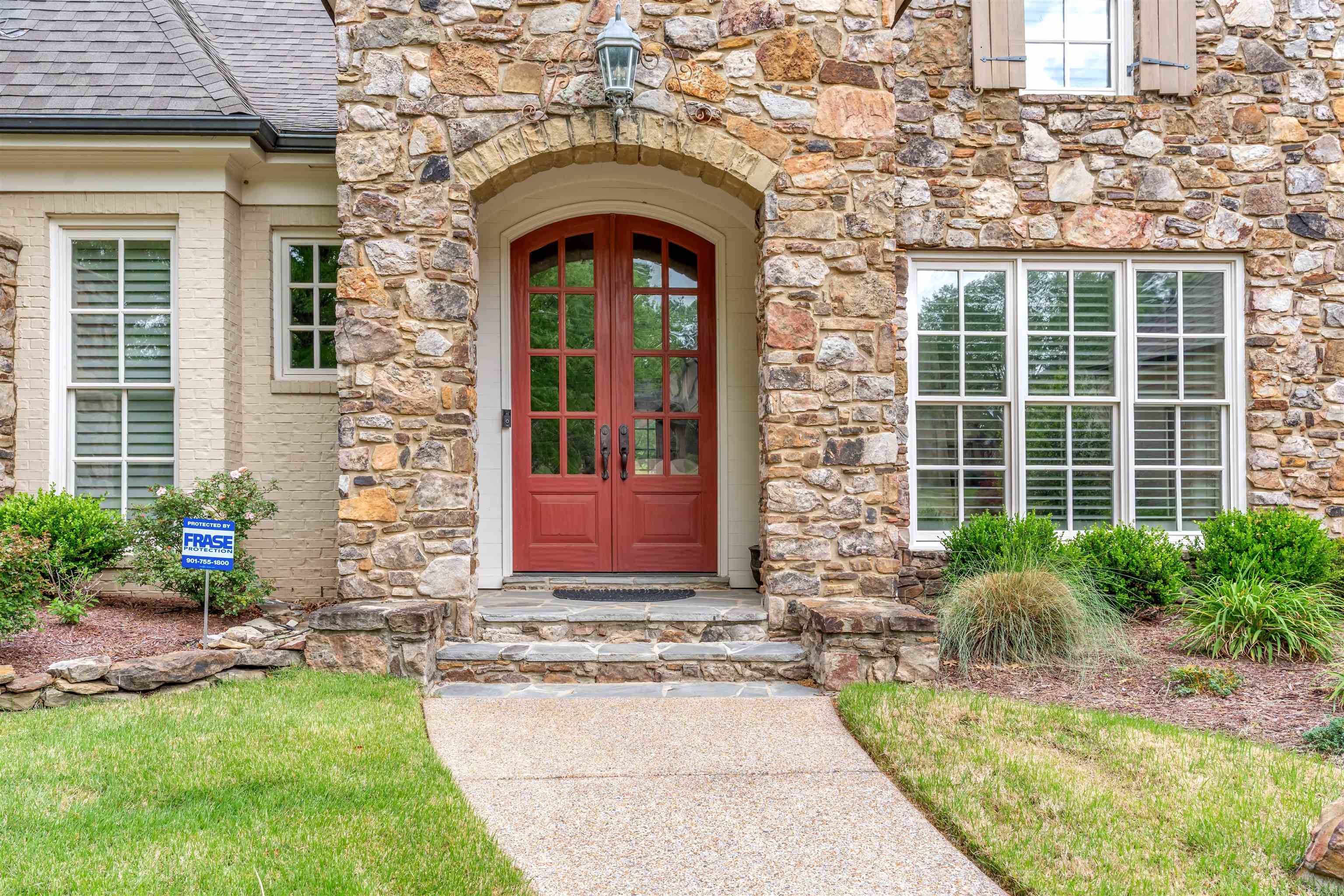 1218 Braystone Trail Collierville, TN 38017 - Photo 2 of 40 Entrance to property with stone siding, french doors, and roof with shingles