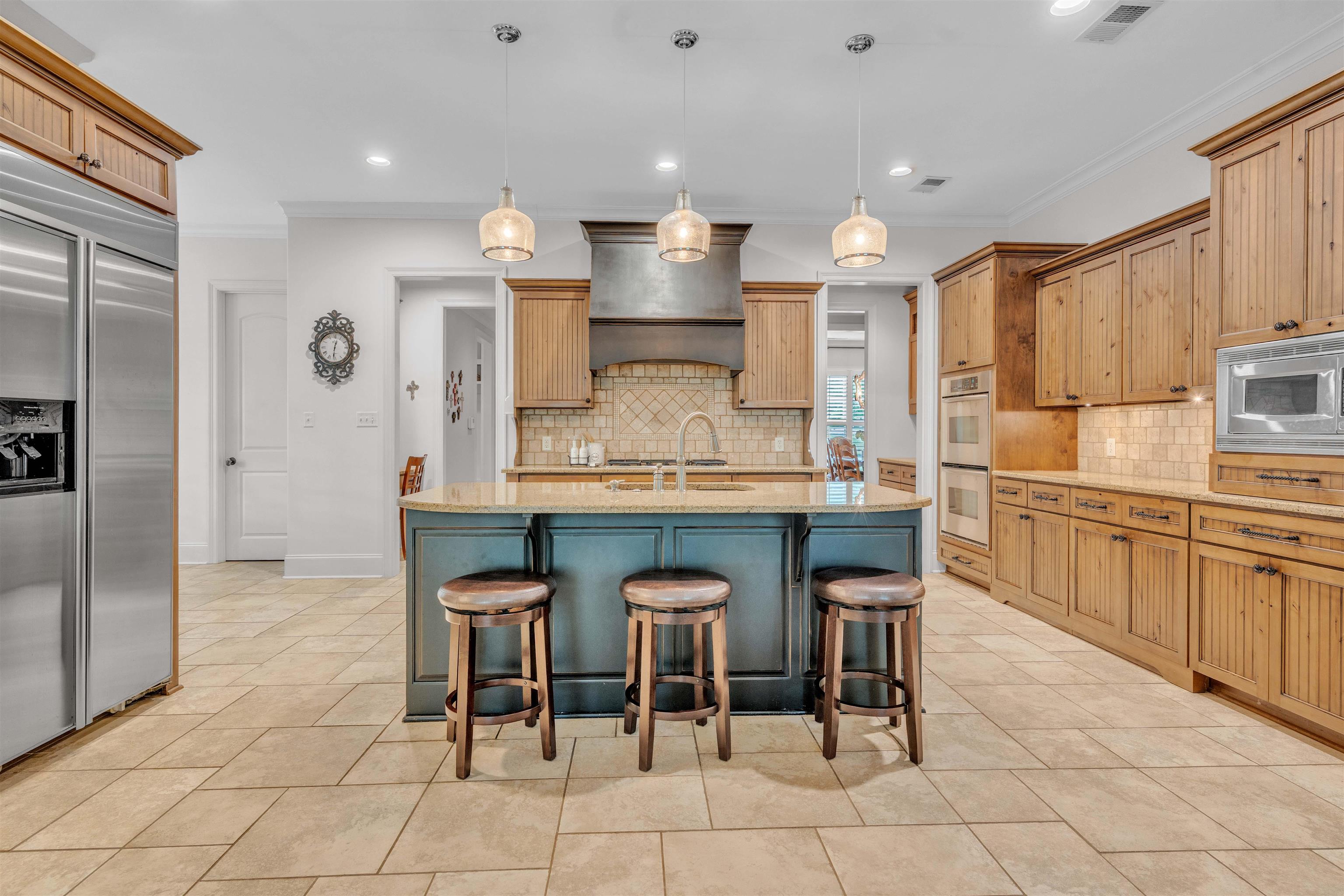 1218 Braystone Trail Collierville, TN 38017 - Photo 21 of 40 a kitchen with granite countertop a table chairs sink and cabinets