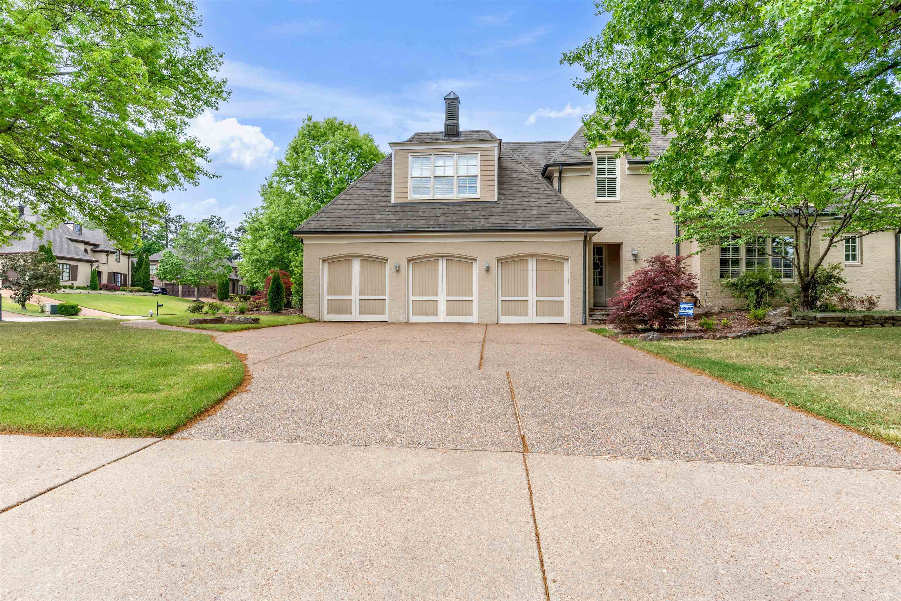 1218 Braystone Trail Collierville, TN 38017 - Photo 35 of 40 View of front of property with a front lawn, concrete driveway, a shingled roof, an attached garage, and stucco siding