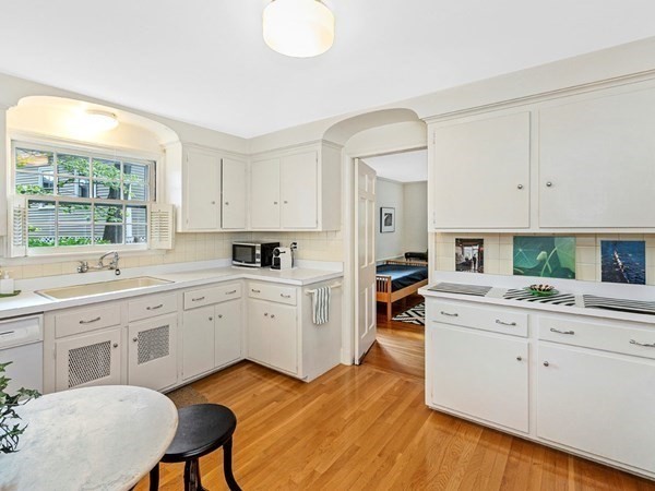 8 Monadnock Road Arlington, MA 02476 - Photo 11 of 36 a kitchen with white cabinets and white appliances