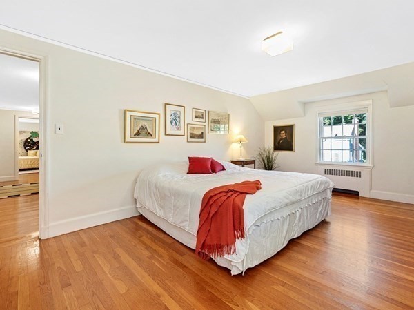8 Monadnock Road Arlington, MA 02476 - Photo 20 of 36 a bedroom with a bed and wooden floor