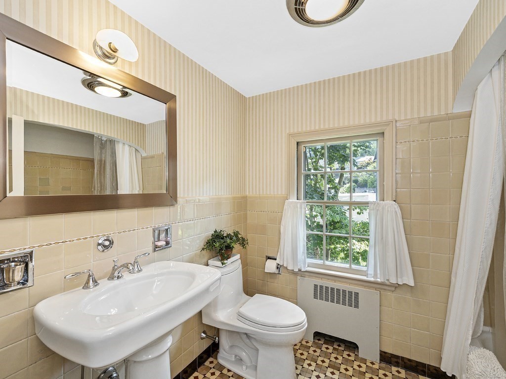 8 Monadnock Road Arlington, MA 02476 - Photo 25 of 36 a bathroom with a toilet sink and mirror