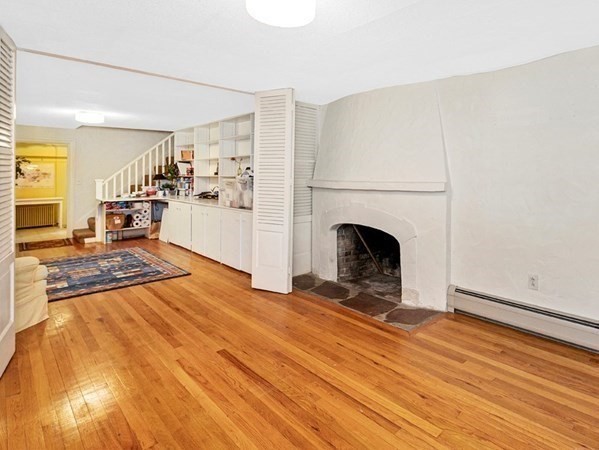 8 Monadnock Road Arlington, MA 02476 - Photo 27 of 36 a view of a livingroom with wooden floor and a fireplace