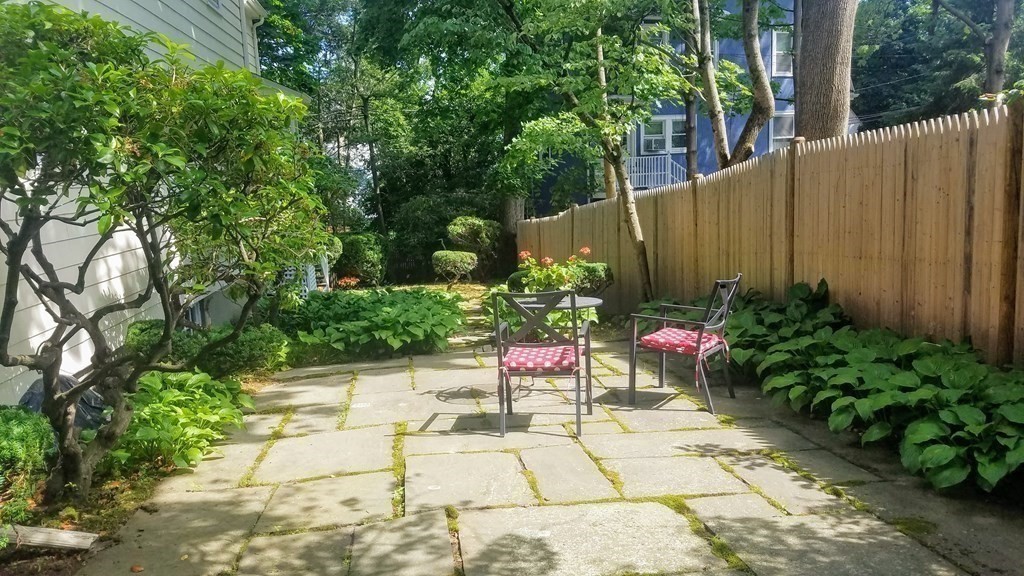 8 Monadnock Road Arlington, MA 02476 - Photo 31 of 36 a view of a chair and table in the backyard