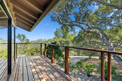 a view of balcony with wooden floor